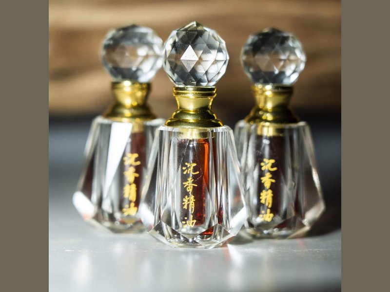 Oud oil aging in practice: hydro-distilled oud oil in a sealed glass bottle, stored dark and cool