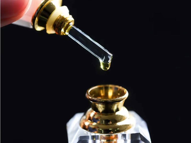 Pure oud oil in a small glass vial, the concentrated ingredient behind every true oud attar