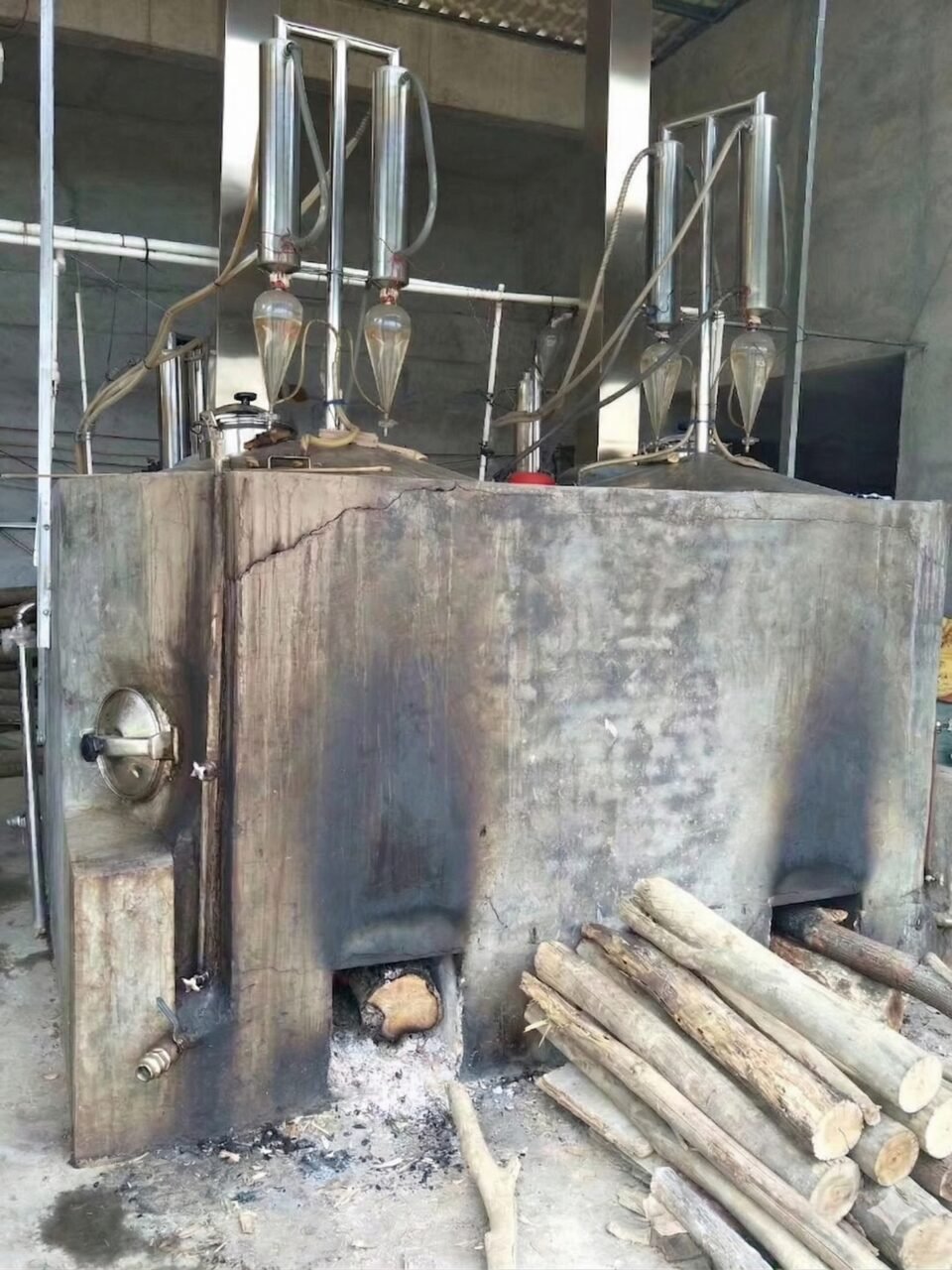 Traditional copper still hydro-distilling agarwood essential oil from soaked Aquilaria sinensis chips